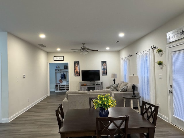 dining space with ceiling fan and dark hardwood / wood-style floors