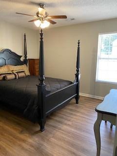 bedroom featuring hardwood / wood-style flooring and ceiling fan