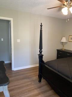 bedroom featuring ceiling fan and dark wood-type flooring