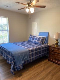 bedroom featuring ceiling fan and wood-type flooring