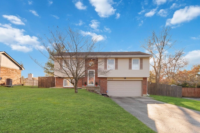 split foyer home with a front lawn, central AC unit, and a garage