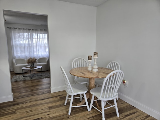 dining room with dark hardwood / wood-style flooring