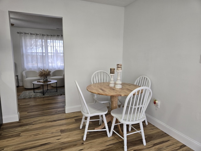 dining room with dark hardwood / wood-style flooring