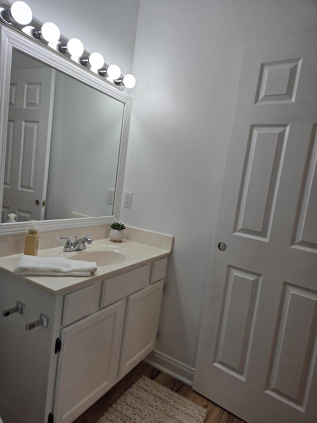 bathroom with vanity and hardwood / wood-style flooring