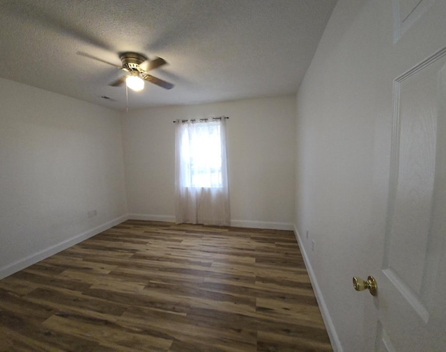 unfurnished room featuring dark hardwood / wood-style floors, ceiling fan, and a textured ceiling