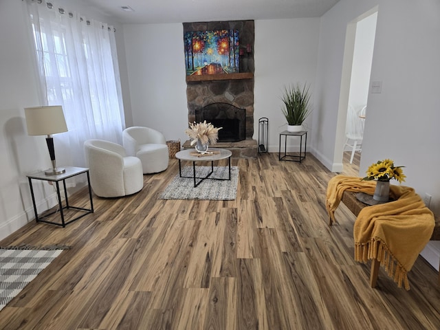 living area featuring hardwood / wood-style floors and a fireplace