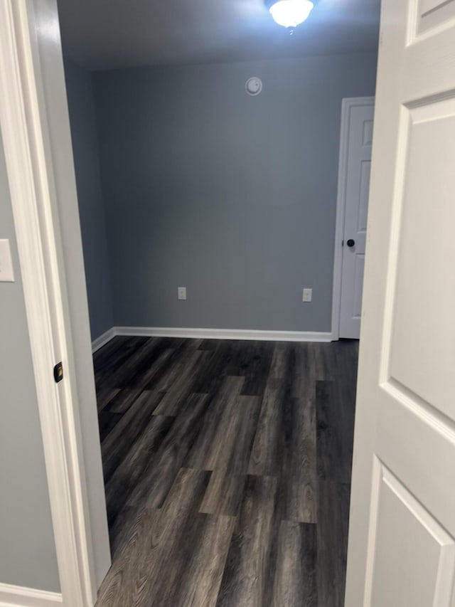 unfurnished room featuring dark hardwood / wood-style floors