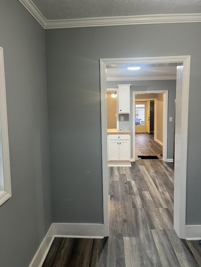 hall featuring dark hardwood / wood-style flooring and crown molding