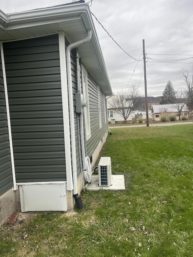 view of home's exterior with a yard