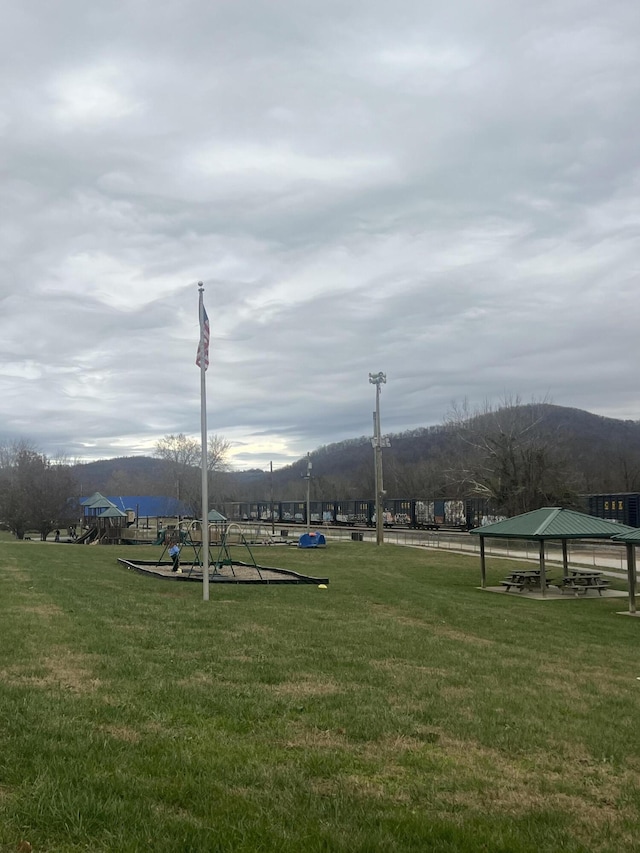 surrounding community featuring a gazebo, a mountain view, and a yard