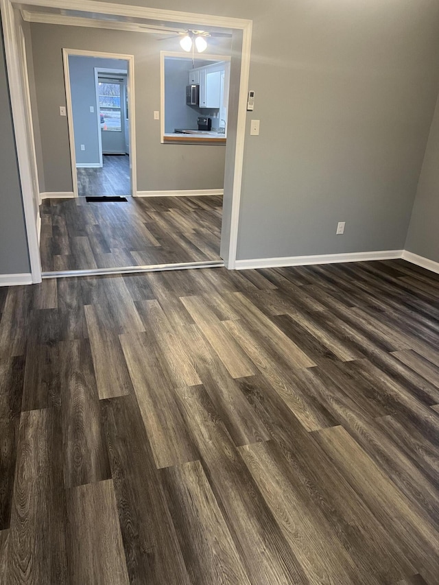 interior space with dark hardwood / wood-style floors and crown molding