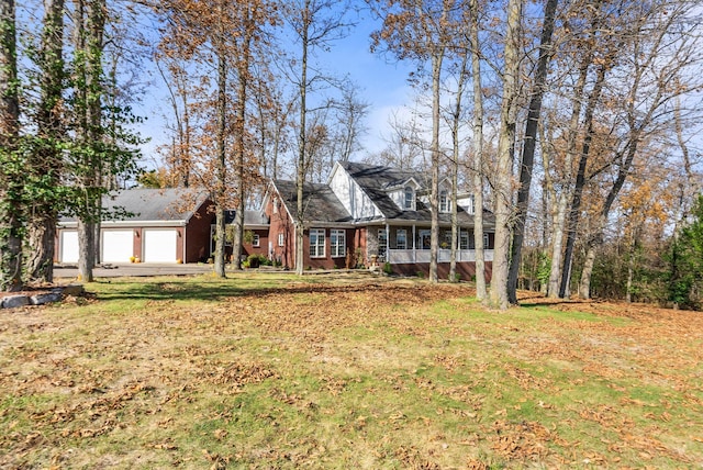 cape cod-style house featuring brick siding and a front lawn