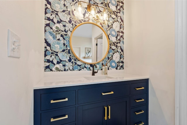 bathroom with wallpapered walls and vanity