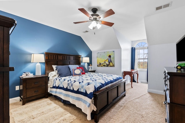 bedroom featuring visible vents, light carpet, baseboards, and vaulted ceiling