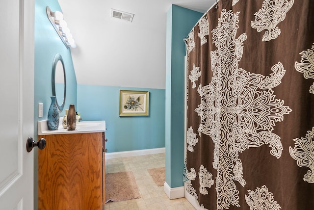 full bath with vanity, baseboards, and visible vents