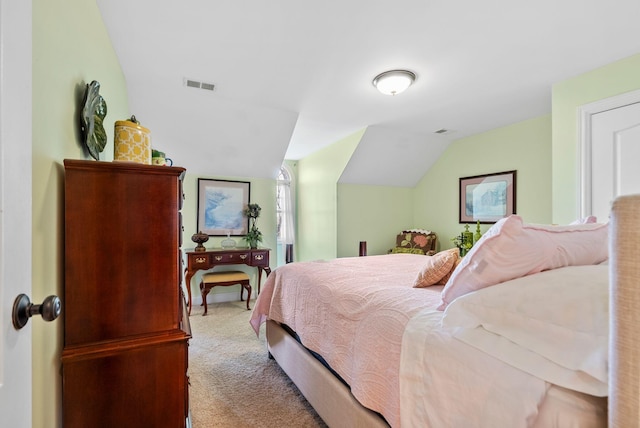 bedroom featuring visible vents, lofted ceiling, and carpet floors