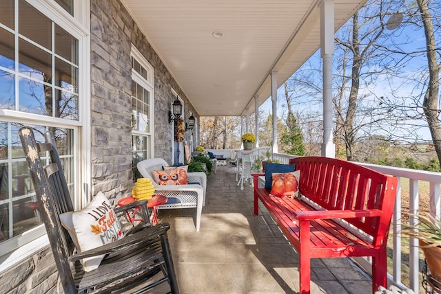 balcony with covered porch and outdoor lounge area