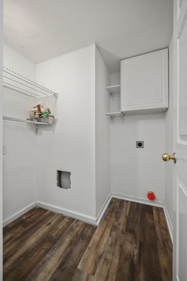 laundry area with electric dryer hookup, a textured ceiling, and dark hardwood / wood-style floors