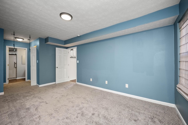 interior space featuring carpet and a textured ceiling