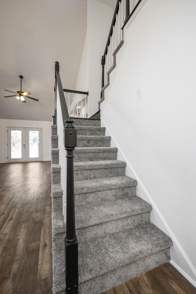 stairway featuring french doors, hardwood / wood-style flooring, ceiling fan, and lofted ceiling