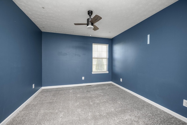 carpeted spare room with ceiling fan and a textured ceiling