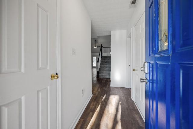 foyer with ceiling fan, dark hardwood / wood-style flooring, and a textured ceiling