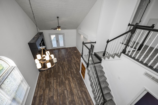 entrance foyer featuring plenty of natural light, vaulted ceiling, dark wood-type flooring, and french doors