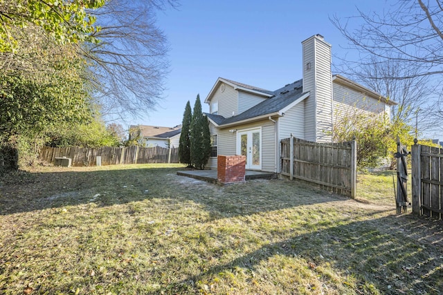 rear view of property with a yard and french doors