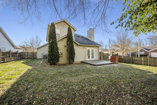 rear view of property with french doors, a patio, and a lawn