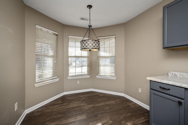 unfurnished dining area featuring dark hardwood / wood-style flooring