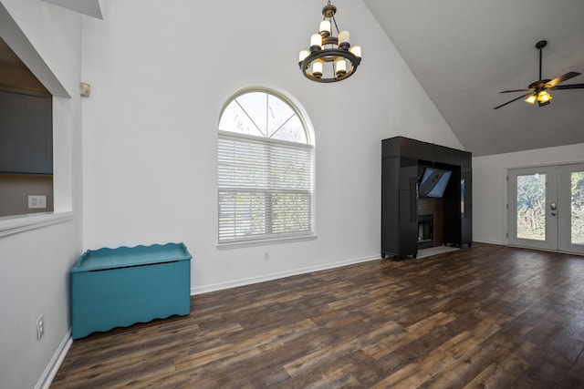 unfurnished living room with plenty of natural light, high vaulted ceiling, and dark hardwood / wood-style floors