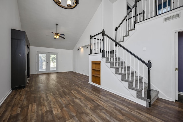 unfurnished living room featuring french doors, dark hardwood / wood-style flooring, high vaulted ceiling, and ceiling fan