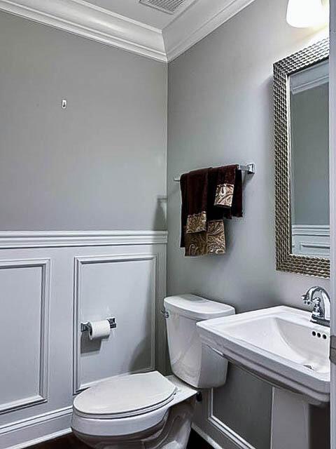 bathroom with toilet and crown molding