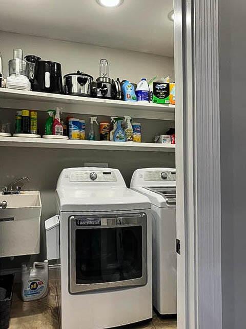 laundry room with washer and dryer and sink