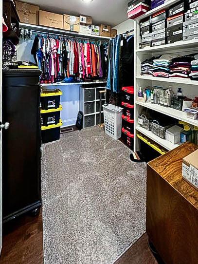 spacious closet featuring dark colored carpet