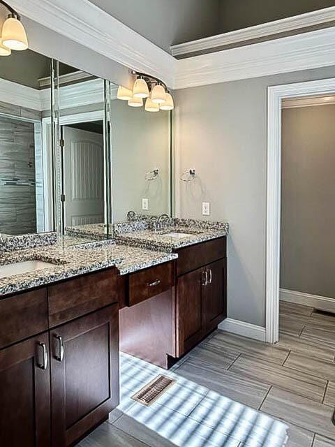 bathroom featuring vanity and crown molding