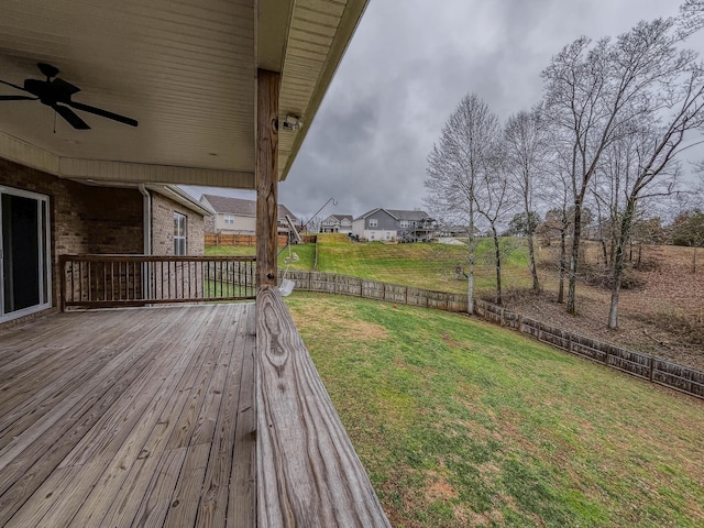 view of yard featuring ceiling fan and a deck