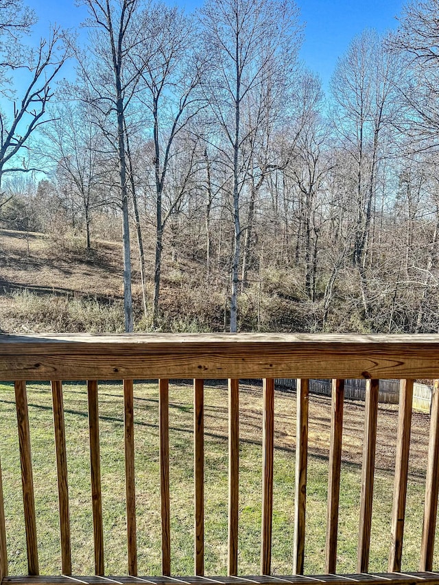 wooden deck featuring a yard