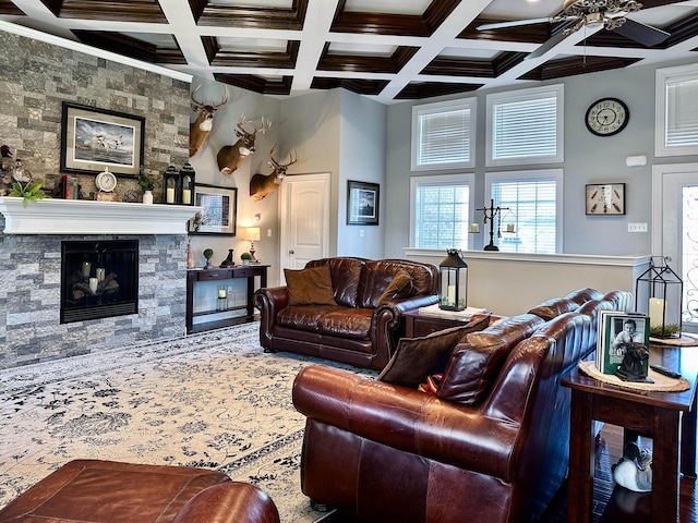 living room with a fireplace, beamed ceiling, coffered ceiling, and a high ceiling