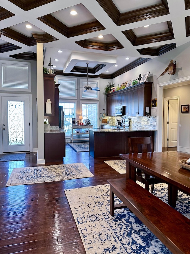 kitchen with beamed ceiling, dark hardwood / wood-style floors, ceiling fan, and coffered ceiling