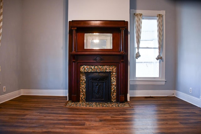 interior details featuring a tiled fireplace and hardwood / wood-style floors