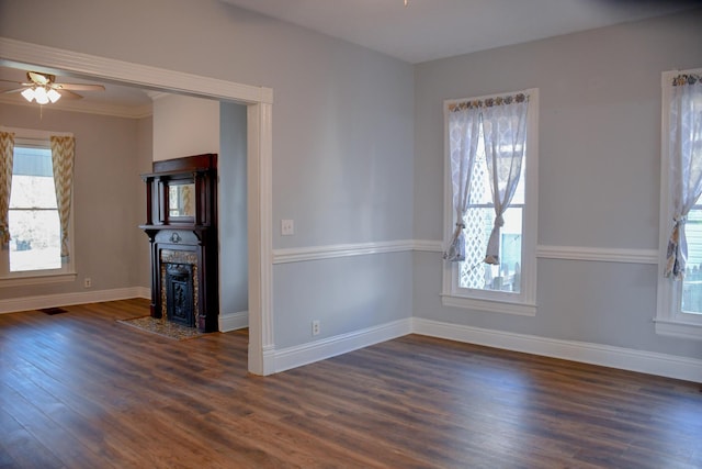 unfurnished room featuring dark hardwood / wood-style floors, a wealth of natural light, and ceiling fan