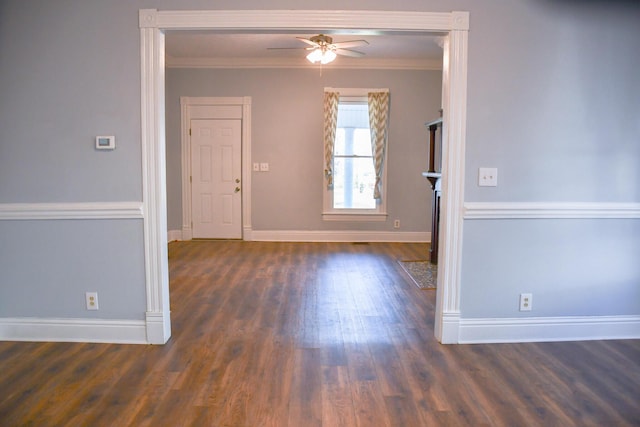 unfurnished room with ornamental molding, ceiling fan, and dark wood-type flooring