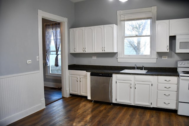 kitchen featuring dark hardwood / wood-style flooring, white appliances, white cabinetry, and sink