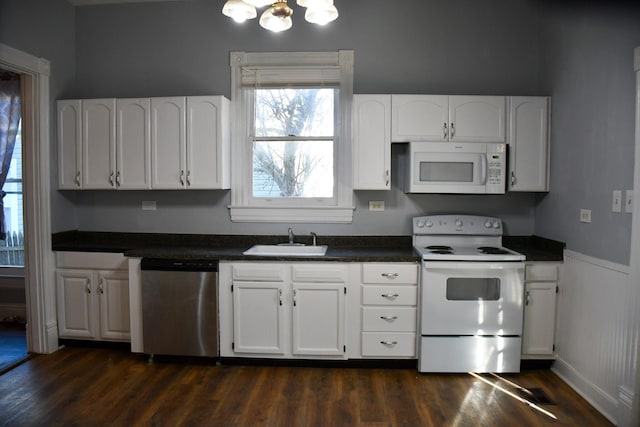 kitchen with white cabinets, dark hardwood / wood-style floors, white appliances, and sink