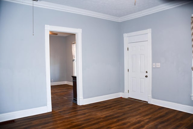 unfurnished room with a textured ceiling, ornamental molding, and dark wood-type flooring