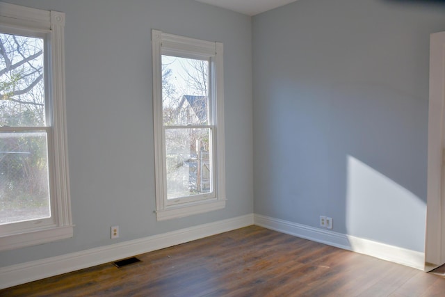 empty room featuring dark wood-type flooring