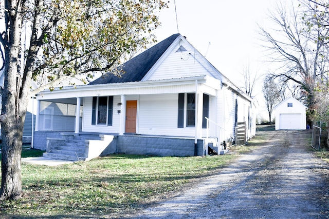 bungalow featuring covered porch, a garage, and an outdoor structure