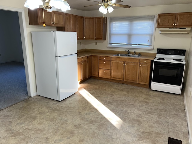 kitchen with ceiling fan, white appliances, sink, and light carpet