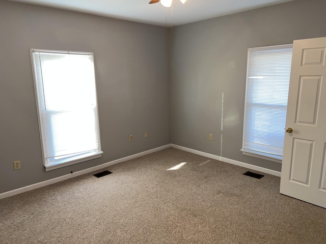 carpeted empty room featuring ceiling fan